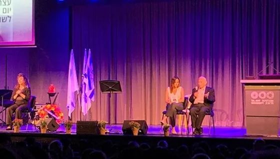 Yitzhak Wolster, his granddaughter, Noga Shahar and Iris Ben Moshe, a sign language interpreter, at the Holocaust Remembrance Day 2025.